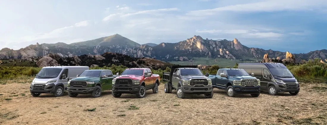 Ram trucks lined up in a row in front of mountains